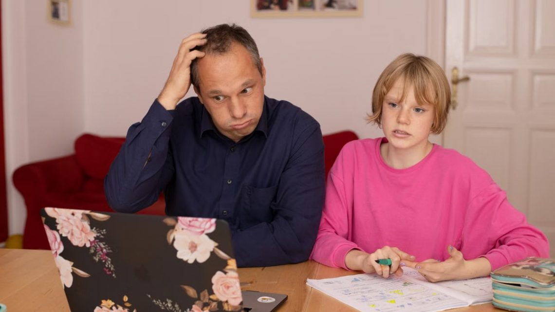 A father and daughter working on a laptop, focusing on home education activities.